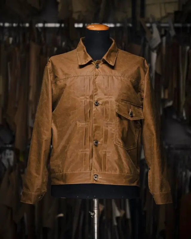 LIMITED EDITION 25 pcs worldwide

Inspired by the original 1900s Type I jacket and revisited with a unique Italian touch, the “Type I” Bronze Waxed Canvas Jacket represents an authentic garment made of 100% Cotton Waxed Desert 12 Oz by Halley Stevensons, one of the oldest waxed cotton mills in the world (since 1864 in Dundee, Scotland).

The Type I jacket is a classic piece of American workwear history, originally introduced in the early 1900s, one of the most iconic jacket styles in the world. The Type I was born out of the need for rugged, durable outerwear during a time when denim was used almost exclusively for workwear. It quickly became a favorite among railroad workers, miners, and ranchers due to its toughness and practicality. This jacket represented not just a garment, but a lifestyle of hard work and resilience.

The Waxed Canvas Desert 12 Oz by halleystevensons provided an extraordinary layer of protection against any bad weather conditions: wind, rain and mud. As the name suggests, Desert is a dry wax finish. The fabric has been through a tumbling process which softens the firm handle and gives the distressed worn appearance with a unique vintage aesthetic.

The attention to detail makes it a rare and authentic Waxed Jacket Hand Made in Italy.

Designed for Bikers, Rockers and Gentlemen.

This is a “1 of 1 piece” exclusive to you.

Proudly Hand Made in Italy