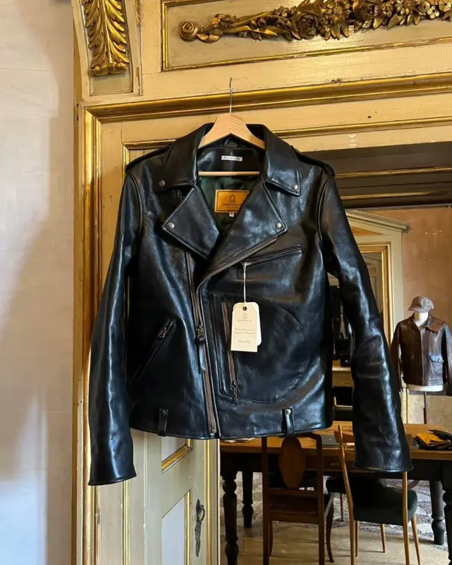 Inspired by 1950s Motorcycle jackets and revisited with a unique Italian touch, the “Chiodo” Black Horsehide Leather Jacket represents an authentic garment made of chrome tanned, drum dyed, full grain Horsehide from Vicenza (Italy).

The Full Grain Horsehide from Vicenza (Italy) is first grade horsehide with a ton of character and deep richness. It ages beautifully, developing fantastic fades, creases and patina. Thickness is around 1,1mm, making the Chiodo an outstanding and high-end premium jacket.

Natural leathers like the Vicenza Horsehide have their own distinctive character and slight differences in texture, grain, scratches and color tone are signs of its authenticity.

A double-breasted front provides an additional layer of protection to the chest, with a storm flap designed to keep water away from the body, protecting every Rider on the Storm. The most distinctive feature of the jacket, however, remains the legendary D-Pocket, also known as the “Gun,” or “Map” pocket.

The lining is made of a Special Edition “Pied de Poule” in Forest Green color 100% Viscose.

The metallic zippers are made of antique brass with engraved markings.

The attention to detail makes it a rare and authentic Horse Leather Jacket Hand Made in Italy.

Designed for Bikers, Rockers and Gentlemen.

Any imperfections or variations in color, texture or grain are not to be considered as defects, but distinctive elements of a unique, artisanal quality product.

This is a “1 of 1 piece” exclusive to you.

Proudly Hand Made in Italy